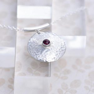 round silver pendant with Garnet in the centre made iana jewellery ips64